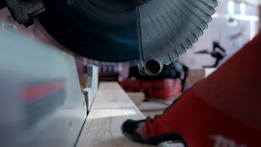 Saw, electric power carpentry tools. cutting wood beam on construction site