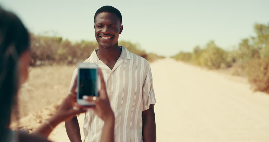 Phone, photograph and travel with couple in desert together for honeymoon, road trip or vacation. Arms crossed, profile picture and social media with people outdoor for bonding, journey or holiday