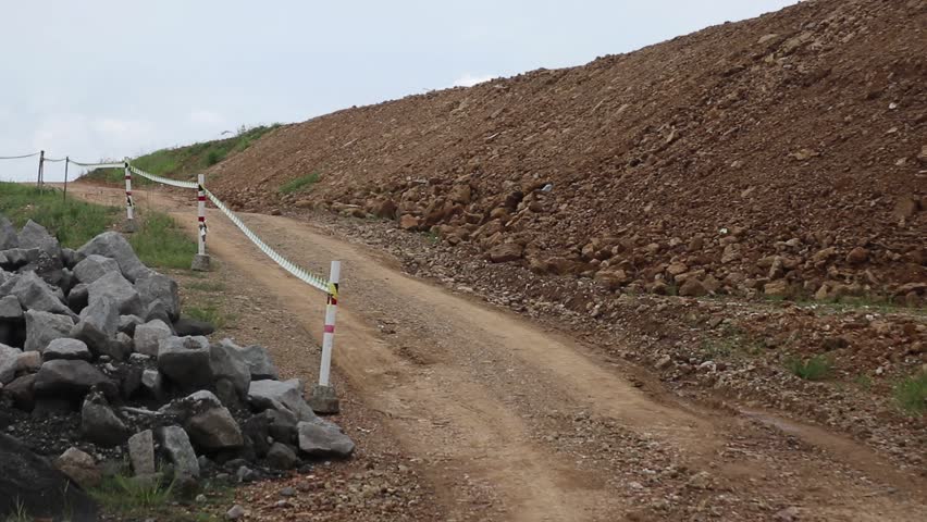 Mud roads between stone materials and brown rock hills