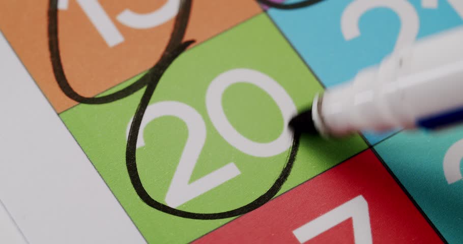 Close-up image of a calendar with the number 20 highlighted in a black circle, representing an important date or event. Close-Up of Calendar Date with Important Day Marked in Black Circle