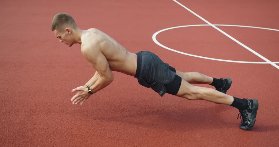 Outdoor Fitness Park. Working out for good health. Fitness and sport lifestyle. Sports, health care, fitness routine, workout. Strength, motivation. Sporty muscular male has physical training outside