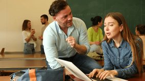 Man trying to flirt with woman during recess in university. Students meet in classroom. - Powered by Shutterstock - Get 15% off with code: PIKWIZARD15