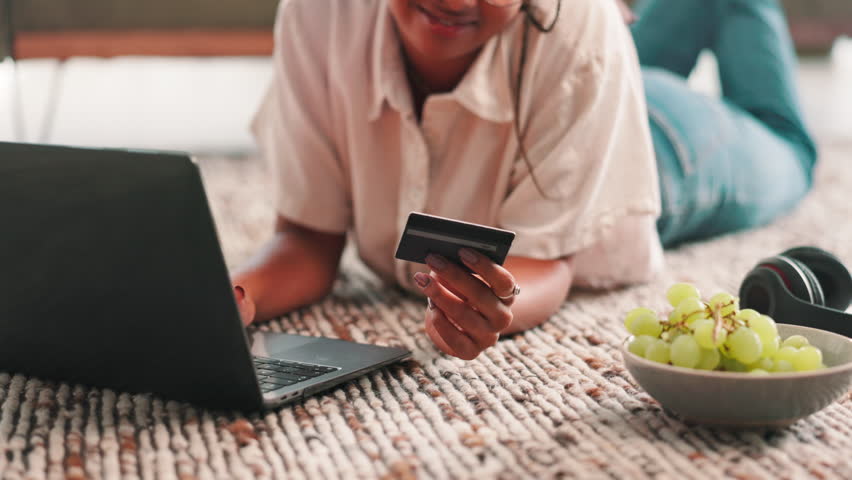 Online shopping, hands and woman with debit card, laptop and browsing on website for ecommerce in home. House, customer and person with credit for payment, happiness and choice for digital product