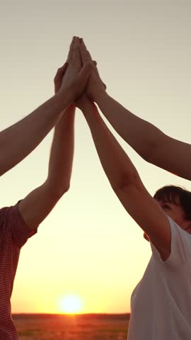 Business team of people in nature, team success. People join hands close-up against, sun sky. Group of business people raise hands, join hands together. Team spirit, holding hands. Teamwork concept