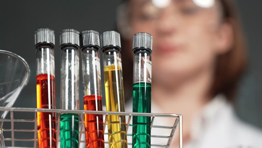 Professional scientist bring colored solution or chemical liquid doing experiment at laboratory. Skilled teacher bring biological sample to look under microscope in STEM science class. Erudition. - Powered by Shutterstock - Get 15% off with code: PIKWIZARD15