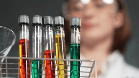 Professional scientist bring colored solution or chemical liquid doing experiment at laboratory. Skilled teacher bring biological sample to look under microscope in STEM science class. Erudition. - Powered by Shutterstock - Get 15% off with code: PIKWIZARD15
