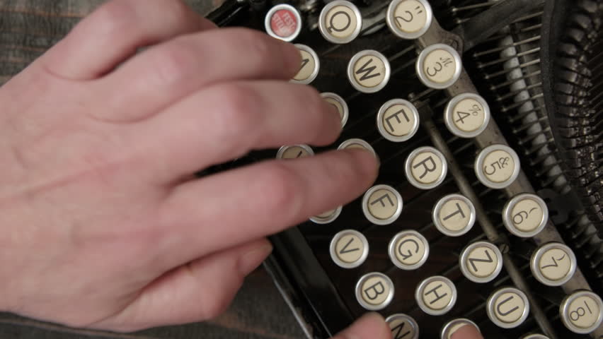 Typing process on vintage typewriter close-up