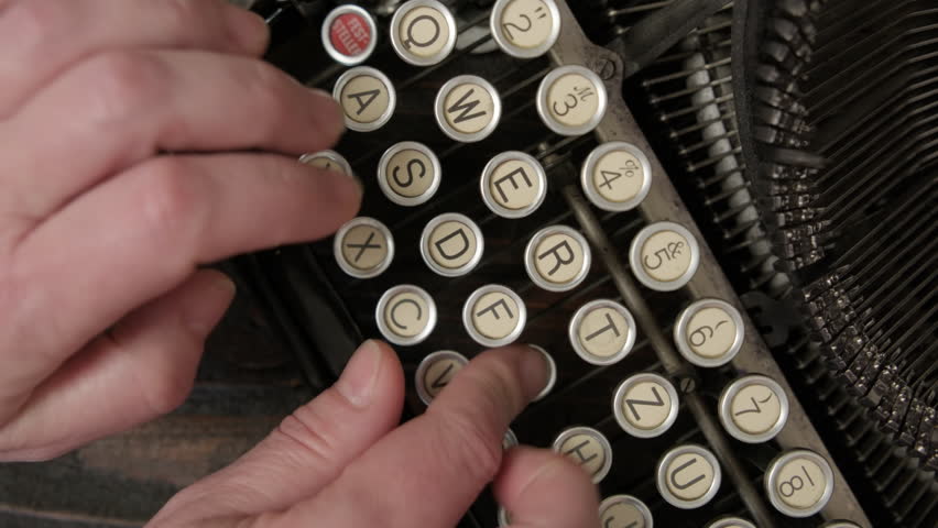 Typing process on vintage typewriter close-up
