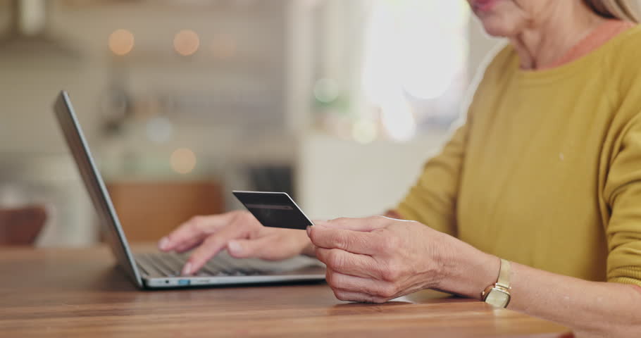 Senior woman, credit card and laptop for payment in home, ecommerce and internet banking for transaction. Elderly female person, finance and typing account number on website, online and investment