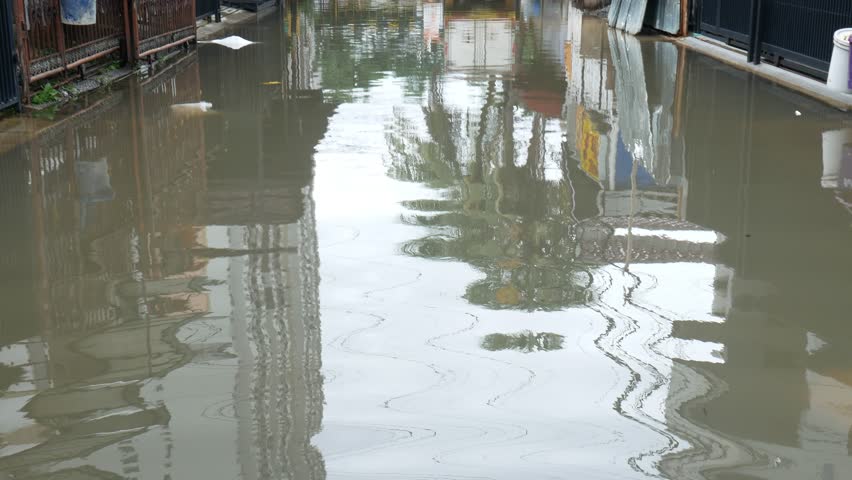 dirty high street flood water, air banjir tinggi kotor, in kelapa gading housing, north jakarta, jakarta utara, indonesia, 29 January 2025