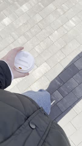 POV Walking on City Sidewalk with Coffee Cup, Shadow, Legs and Feet in Sunny Weather, Vertical Video for Social Media