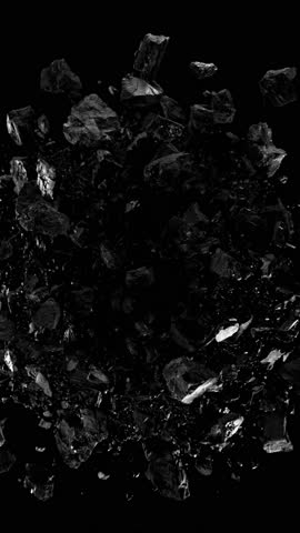 Super slow motion of rotating coal pieces on black background. Filmed on high speed cinema camera, 1000fps. Speed ramp effect. Vertical aspect ratio.