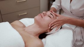 Beautician doing facial massage to young beautiful woman, close-up. Lifting procedure in a spa salon. Professional skin detox. Concept relaxing massage, beauty salon, cosmetology, wellness - Powered by Shutterstock - Get 15% off with code: PIKWIZARD15