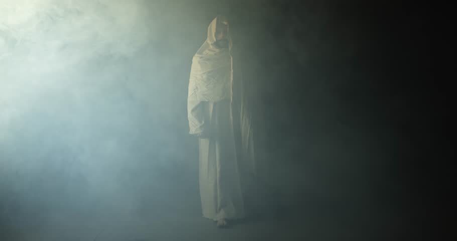 Jesus Christ shrouded in ambient bright light, symbolizing the resurrected Jesus Christ inside the tomb in bright, dramatic, glowing, holy light as representation of the Easter Sunday resurrection.