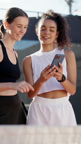 Women, friends and phone with laughing at tennis court for funny meme, point or video on web in summer. Girl, people and athlete on smartphone, mobile app and comic update on social media with sports