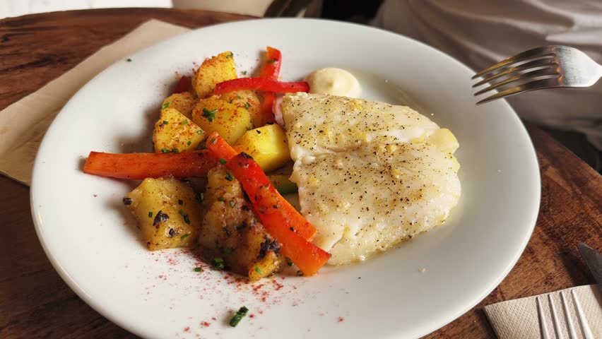 Steamed cod with grilled vegetables and aioli sauce, healthy tasty food. High quality 4k footage