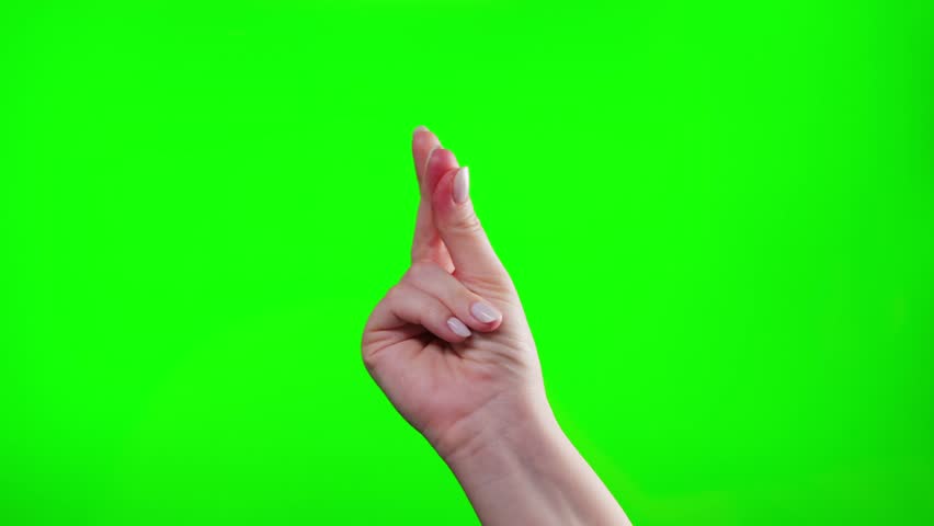 Close-up of hand snapping finger making hand gesture isolated on green chroma key background. High quality 4k footage