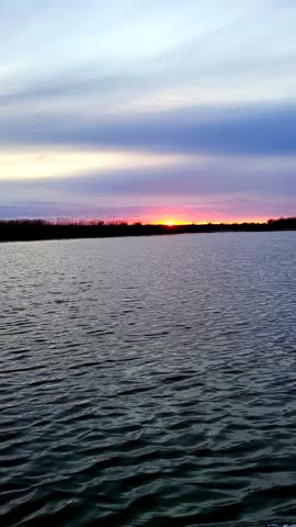 Beautiful sunset on the lake, taken from a moving boat