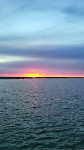Beautiful sunset on the lake, taken from a moving boat