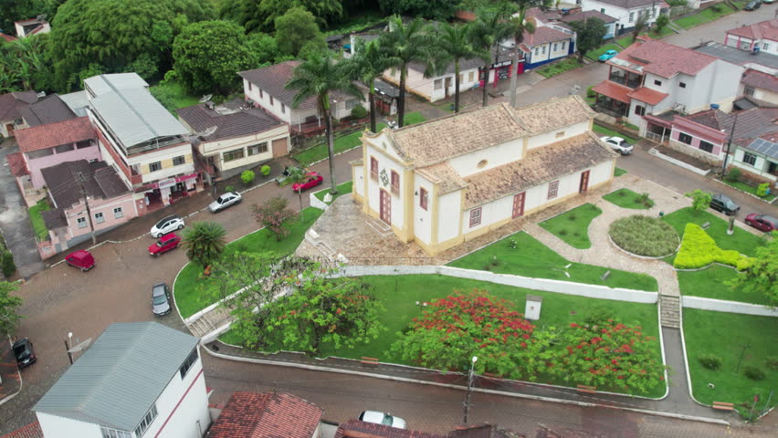 An overhead drone view of the Igreja do Rosário, with its beautiful surroundings, a city square, and the charming town of Andrelândia, in the state of Minas Gerais, Brazil.