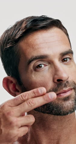 Studio, face and skincare for man, cosmetics and facial treatment for glow of skin, beauty and dermatology. White background, grooming and person with routine for self care, moisturiser and USA