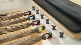 Coiled Metal Springs Of Pilates Reformer, Attached With Color-coded Rings To Adjust Resistance During Workout. closeup shot - Powered by Shutterstock - Get 15% off with code: PIKWIZARD15