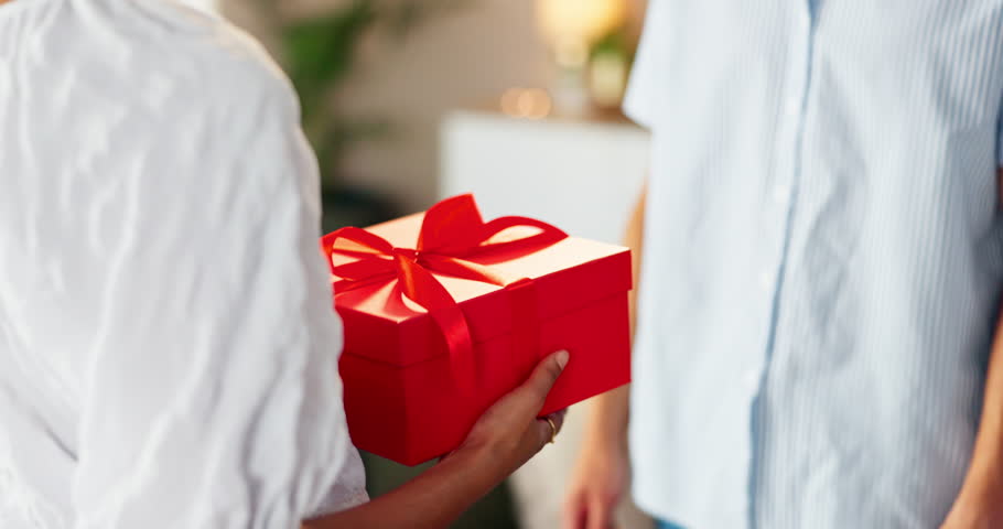 Couple love, hands and romantic with gift box for valentines day, surprise gesture and present for anniversary. Care, people and giving ribbon package for celebration, special date or support in home