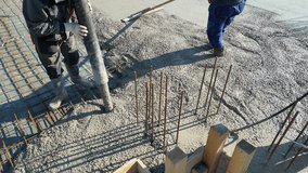 Construction workers with concrete boom pump crane at construction site pouring concrete into a formwork with reinforcement for building a new house - Powered by Shutterstock - Get 15% off with code: PIKWIZARD15