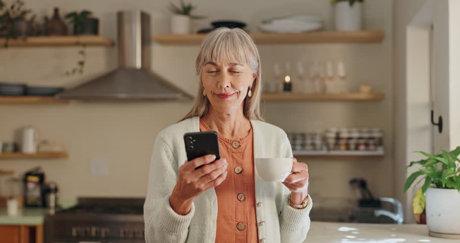 Senior woman, phone and typing with tea in home, reading notification and scroll on blog. Elderly female person, typing and text for communication, coffee and social media for funny joke or laugh
