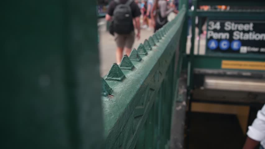 New York City subway sign, underground metro station. Metropolitan entrance green fence, Manhattan public transport exit. Pedestrians people. 34 street, Penn Station, United States passenger railroad.