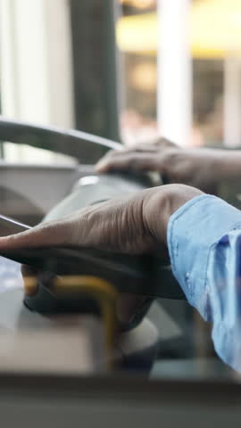 Commute, steering wheel and hands of person on bus for navigation, shuttle service and driving journey. Travel, public transportation and route with closeup of driver for location, traffic and trip