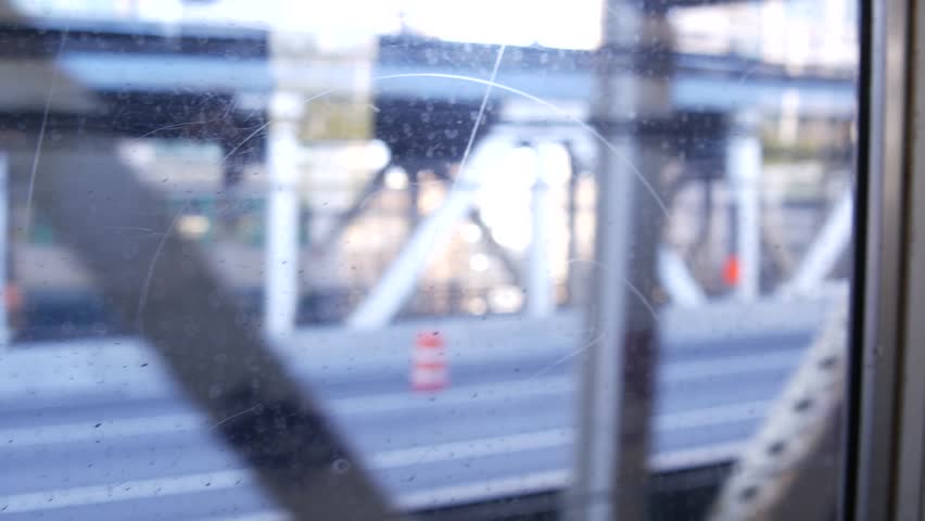 New York City subway train, Manhattan bridge. Shaking camera thru dirty window. Downtown metro transport, metropolitan traffic. Passenger elevated railway, United States. Urban life of Lower Manhattan