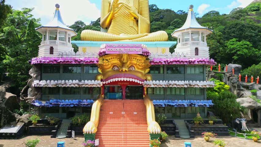 Aerial drone video of the Golden Temple in Sri Lanka. The big gold Buddha