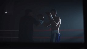 Young African American boxers train fighting together as sparrers on ring. Strong black sportsmen with gloves develop punching skills at sparring in sports club - Powered by Shutterstock - Get 15% off with code: PIKWIZARD15