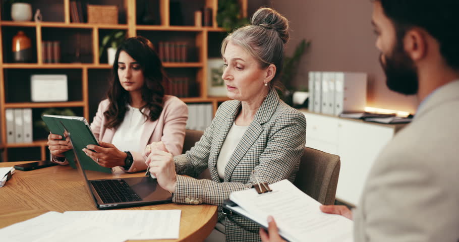 Meeting, documents and lawyer with people in office for legal consulting, case review and strategy. Professional, attorney team and men and women with paperwork for discussion, agreement and planning