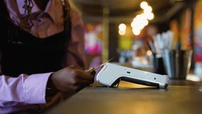 Woman paying with card for lunch at a restaurant counter - Powered by Shutterstock - Get 15% off with code: PIKWIZARD15