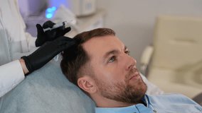 Trichologist performing hair loss injection treatment for man - Powered by Shutterstock - Get 15% off with code: PIKWIZARD15