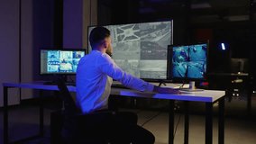 Security officer monitoring surveillance cameras in control room - Powered by Shutterstock - Get 15% off with code: PIKWIZARD15