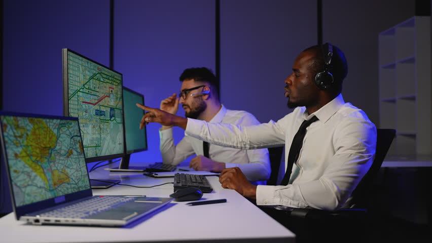 Logistics dispatchers tracking cargo routes in real-time