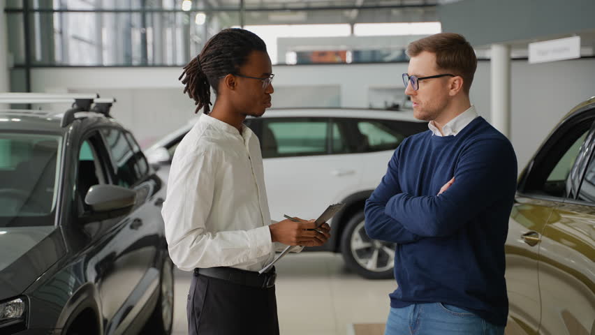 Car Salesman Assisting Customer on Black Friday Sale