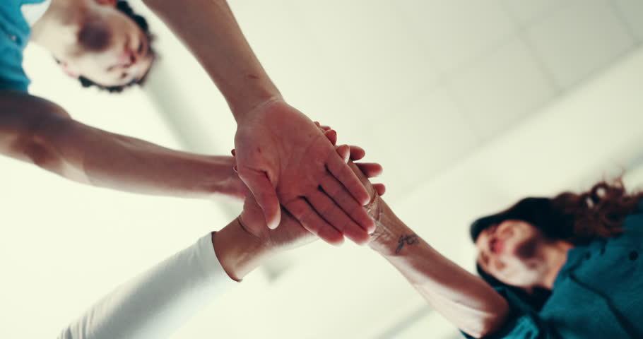 Hands, teamwork and unity in hospital, people and celebration of solidarity for healthcare or nurse. Below, medical professional and colleagues with support in clinic, stack and collaboration to help
