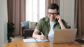 Focused Individual Engages in a Phone Conversation While Working on a Laptop in a Bright, Modern Workspace - Powered by Shutterstock - Get 15% off with code: PIKWIZARD15