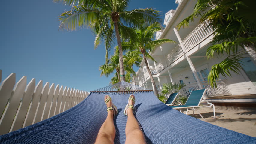 Indulge in the soothing and relaxing vibes of Key West while you lie in a hammock, savoring the breathtaking beauty of Floridas unforgettable sunrises and sunsets, a true escape into paradise