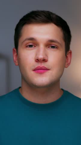Portrait of Adult Man Eating Healthy Food as Looking at Camera. Real Person on Diet Consuming Fresh Red Apple as Quick Lunch Snack. Confident Male Human Inside Cozy Living Room Alone with Organic Meal