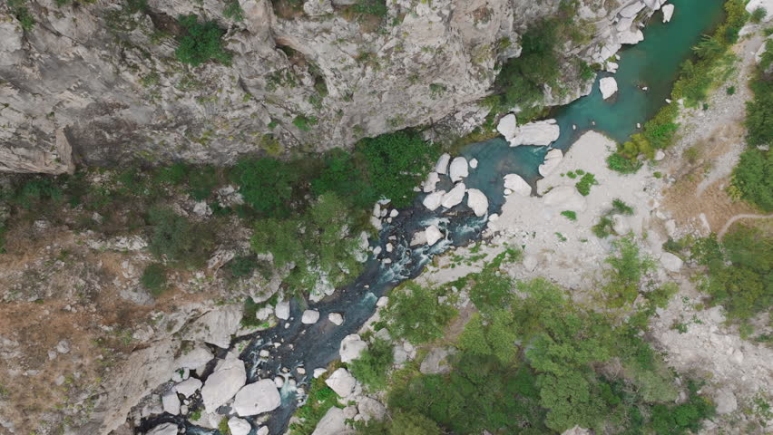 Panoramic aerial view with drone of the natural waters and ecotourism center called Grutas de Xajha, surrounded by enormous mountains