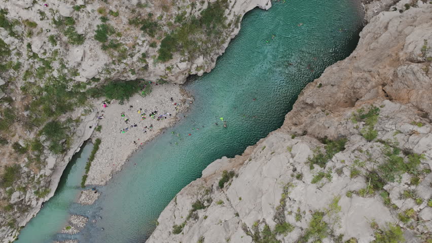Panoramic aerial view with drone of the natural waters and ecotourism center called Grutas de Xajha, surrounded by enormous mountains