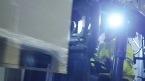 A forklift driver in a yellow jacket navigates the aisles of a vast warehouse, highlighting the precision and efficiency of logistics operations. - Powered by Shutterstock - Get 15% off with code: PIKWIZARD15