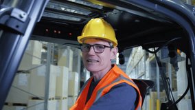 A man in a yellow hard hat and orange safety vest operates a forklift in a warehouse, highlighting the importance of safety in logistics and distribution. - Powered by Shutterstock - Get 15% off with code: PIKWIZARD15