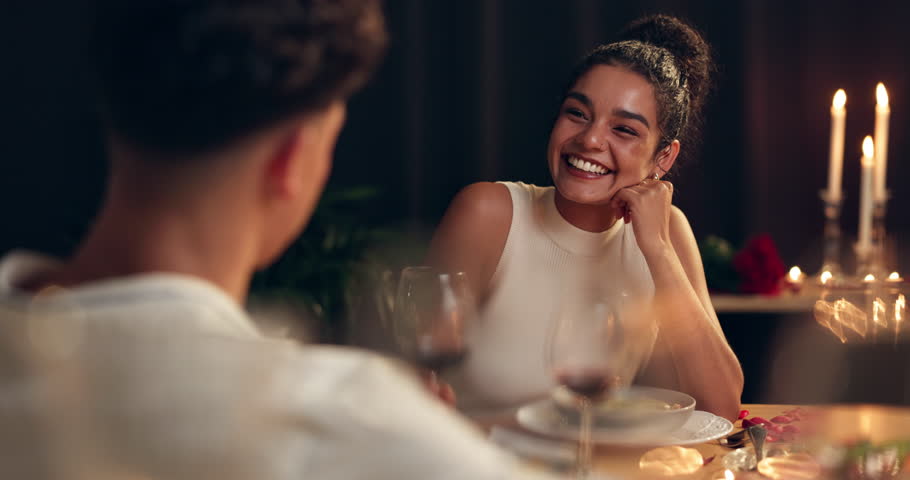 Happy, couple and talking on date at restaurant with romance, valentines day celebration and fine dining. Smile, people and communication for anniversary, commitment and roses of hospitality service