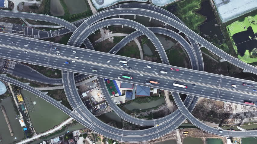 Multi-level overpass China. Lot cars drive on transportation interchange. Road traffic. Chinese economy. Aerial top drone above view of fast urban highway. Modern city freeway. Busy auto express way.